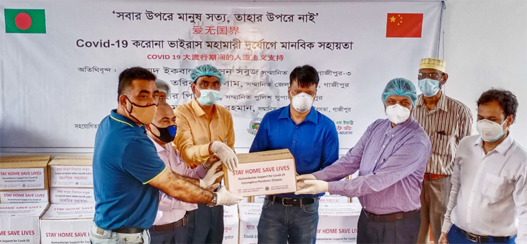 Al Mamun Mridha, Joint Secretary General of Bangladesh China Chamber of Commerce and Industry (BCCCI), handing over Coronavirus protection materials to S M Tarikul Islam, District Commissioner of Gazipur to the latter's office on Wednesday. Anisur Rahman