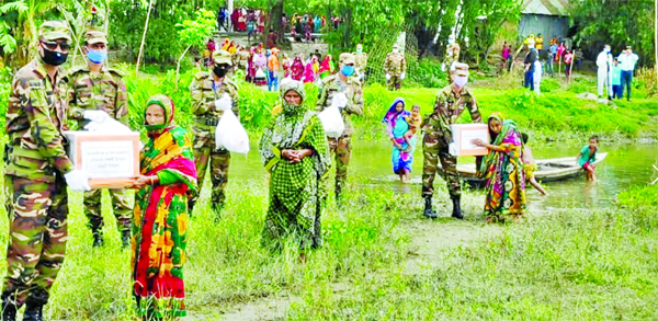 Army personnel distributed relief goods among the destitute people to ensure home quarantine to prevent spread of coronavirus in Lalmonirhat on Friday.