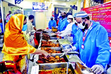 A vendor sells Iftar items from a shop in the city's Bailey Road on Friday following health guidelines and social distancing protocol.