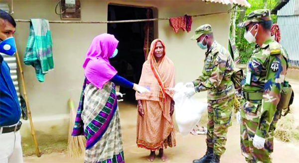 Army personnel distributed relief goods among the poor and destitutes to ensure home quarantine to prevent spread of Covid-19 in Narsingdi on Saturday.