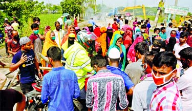 Garment workers block Dhaka-Sylhet Highway at Demra on Saturday demanding arrear wages.