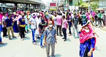 Garment workers blocked the road demanding arrear salaries and bonus in city's Choudhurypara area on Thursday.