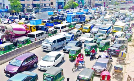 A long queue of vehicles hangs around on the Airport road at Banani on Monday, as traffic picks up with people retruning to work amid a relaxed nationwide shutdown across the country.