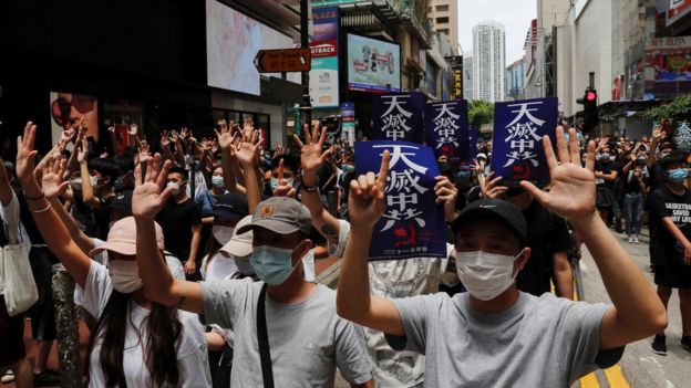 Crowds of protesters march through the city`s popular shopping district