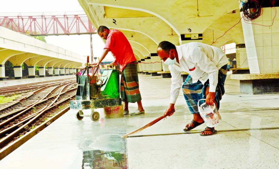 Workers cleaning the Kamalapur Railway Station on Friday morning as the authorities decided to resume the operation of the intercity trains on a limited scale from May 31 which stopped since March 24 to fight the coronavirus outbreak.