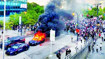 A police car burns as protesters gather near the CNN offices in Atlanta, Georgia on Saturday. Internet photo