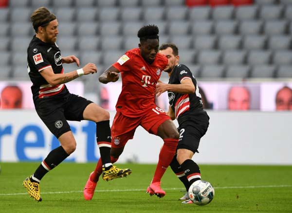 Bayern Munich's Canadian midfielder Alphonso Davies (centre) in action during Saturday's 5-0 win over Fortuna Duesseldorf at the Bundesliga.