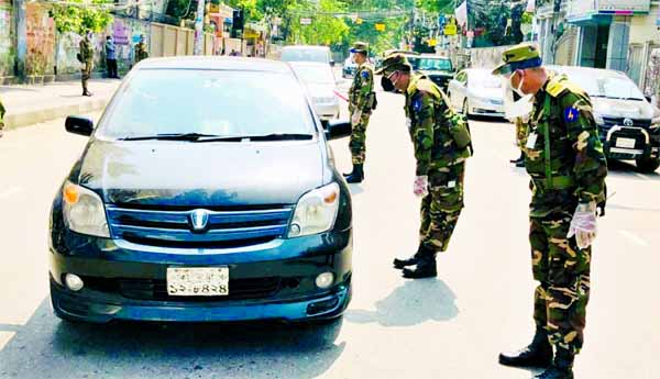 Army personnel intercept a car at the Bhatara area in city on Tuesday to make the people aware for maintaining the health guidelines during the coronavirus pandemic.