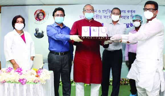 Science and Technology Minister Architect Yeafes Osman handing over handrubs to the Whip of the Parliament Abu Sayeed Al Mahmud Swapan for the members of Parliament to tackle coronavirus at a ceremony held on Wednesday in the DRICM auditorium of BCSIR in