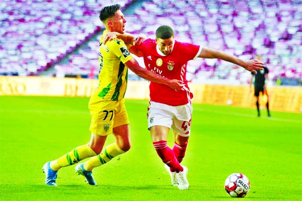 Benfica's player Adel Taarabt (right) vies for the ball with Tondela's Richard Rodrigues during a Portuguese League soccer match between Benfica and Tondela in Lisbon, Portugal on Thursday. The Portuguese League soccer matches resumed Wednesday without