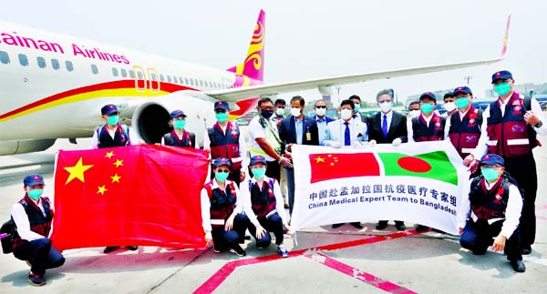 Foreign Minister Dr A K Abdul Momen poses for photograph with a 10-member Chinese medical team who arrived at Hazrat Shahjalal International Airport in the city on Monday to help combat corona crisis.