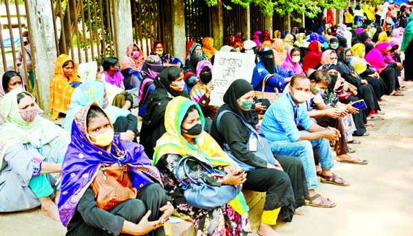 Employees of Dhaka EPZ A One BD Limited stages a sit-in in front of the Jatiya Press Club on Tuesday to meet its various demands including payment of arrear salaries of the employees.