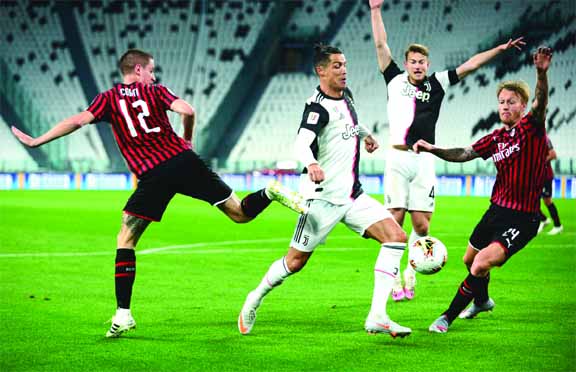 Juventus' Cristiano Ronaldo (center) in action with AC Milan's Andrea Conti (left) and Simon Kjaer (right) during the Italian Cup semi-final Second Leg match in Turin on Friday.