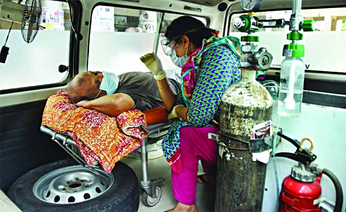 A suspected coronavirus patient waits inside an ambulance for a token so that he can give his swab sample for Covid-19 testing which is necessary to get admission to the Dhaka Medical College Hospital. Everyday, hundreds of people are thronging the hospit