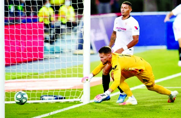 Sevilla's Diego Carlos (back) scores an own goal during the match against Levante at the Ciutat de Valencia stadium in Valencia on Monday.