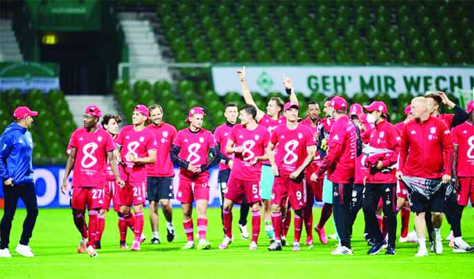 Bayern Munich players celebrate winning their Bundesliga title after defeating Werder Bremen at Weser-Stadion, in Bremen, Germany on Tuesday.