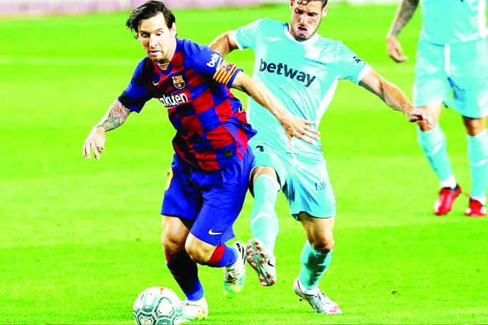 Barcelona's Lionel Messi in action with Leganes' Ruben Perez at the Camp Nou stadium in Barcelona, Spain on Tuesday.