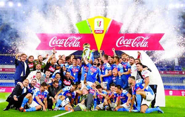 Napoli's players and team staff pose for a group picture with the trophy after the Italian Cup final football match between Napoli and Juventus in Rome, Italy on Wednesday.