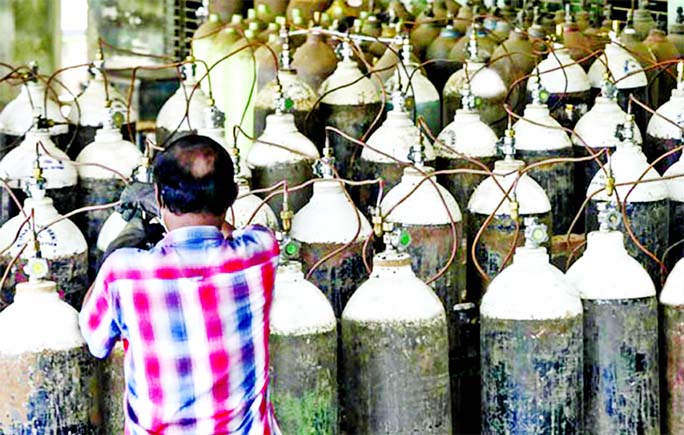 A man refills oxygen cylinders at a workshop in Narayanganjâ€™s Rupganj area on Thursday amid rising demand for medical oxygen due to Coronavirus outbreak.
