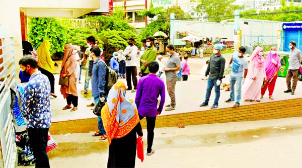 Anxious people stand in a long queue at the Bangabandhu Sheikh Mujib Medical University's fever clinic in Dhaka for coronavirus screening on Friday.