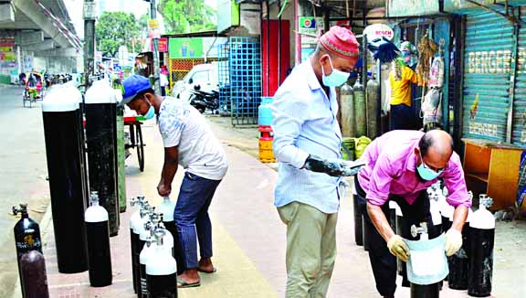 Dishonest traders seen marking expiry dates on the cylinders after colouring afresh in the capitalâ€™s Mogbazar area on Saturday amid rising demand for oxygen in the country due to coronavirus outbreak.