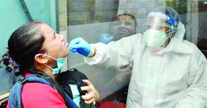 A medical worker collects sample from a woman for the Covid-19 antigen test at a hospital in Chennai on Saturday.