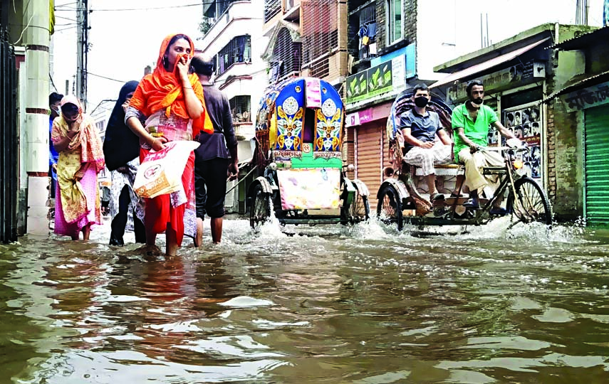Incessant rain for three consecutive days causes waterlogging on the Narayangonj Masdair Bazar Road. This photograph was taken on Saturday.