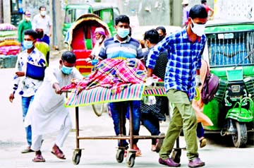 Relatives take a patient to the Dhaka Medical College Hospital to be tested for Coronavirus. This photo was taken on Sunday.