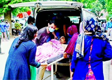As Covid-19 cases spike in Bangladesh, family of a patient takes him to Shaheed Suhrawardy Medical College Hospital on Monday to get tested for Coronavirus.