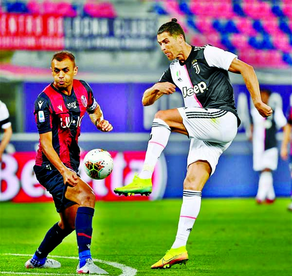 FC Juventus' Cristiano Ronaldo (right) vies with Bologna's Danilo during a Serie A football match between Bologna and FC Juventus in Bologna, Italy on Monday.
