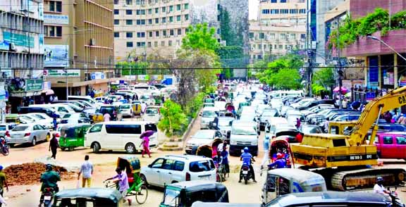 Illegal parking of cars continues to choke the capital's streets causing unending traffic congestions. But the authorities take no interest to free the busy streets. This photo was taken on Tuesday from the commercial hub of Dhaka city, Motijheel, shows