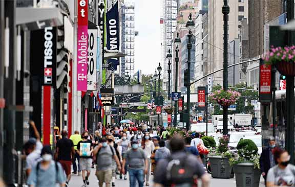 People walk on a street near Herald Square, in New York City on Thursday.