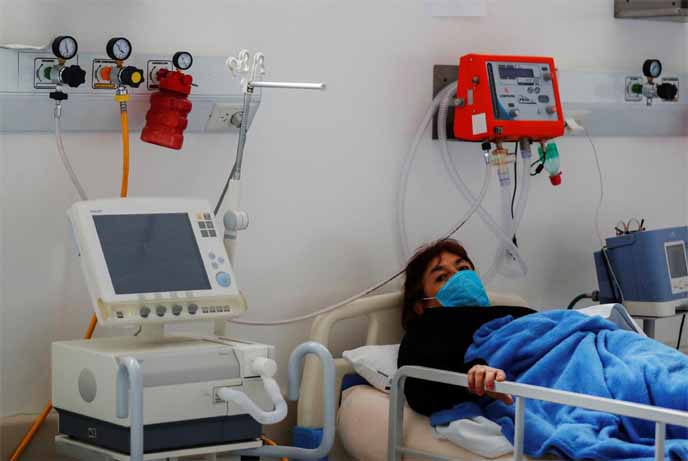 Ana Sandoval, who is infected with the coronavirus, holds onto the railing of her stretcher bed in an Intensive Care Unit (ICU) at the Dr. Alberto Antranik Eurnekian hospital, in Ezeiza, on the outskirts of Buenos Aires Argentina on Thursday.