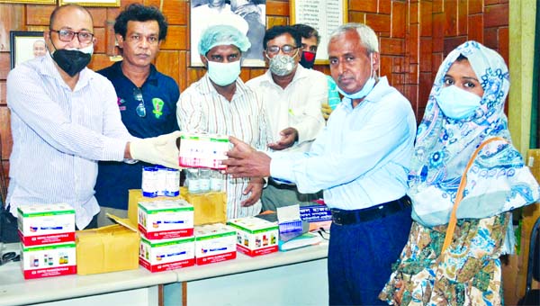 Managing Director of Vertex Laboratories (Homeo) Dr. Md. Azizur Rahman hands over coronavirus preventive Homeopathy medicines, hand sanitizers to Bangladesh Photo Journalistsâ€™ Association Secretary Golam Mustafa on Sunday.