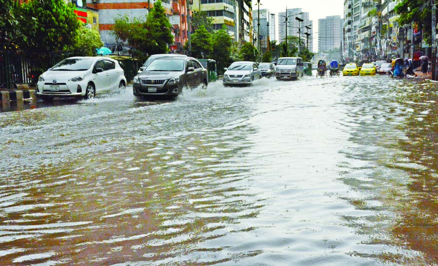 Roads in Dhaka get submerged regularly even after light to moderate rain due to the city's poor drainage system. This photo taken on Sunday shows cars treading on a road in Nayapaltan area that goes under water following monsoon rain.