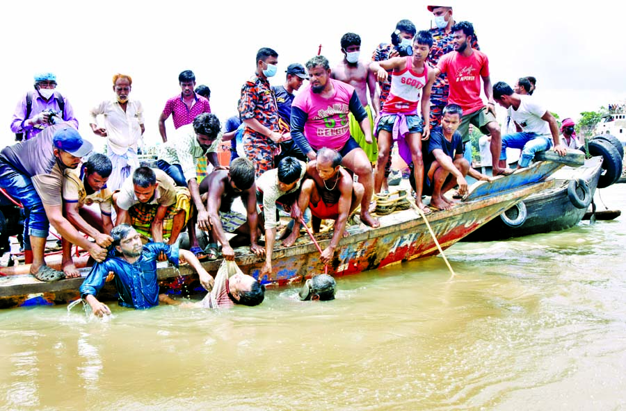 Rescuers search for victims after a launch capsizes in the Buriganga River on Monday following a collision with another launch.