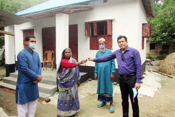 UNO of Kalai Upazila in Joypurhat district Mobarak Hossain Parvez hands over the documents of new houses among the distressed people on Tuesday.