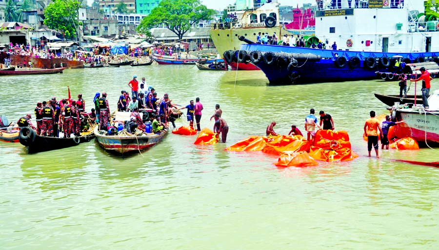 Divers of various government agencies conduct rescue and search operation for the second day to salvage the launch ML Morning Bird which capsized in the Buriganga River on Monday leaving at least 32 people dead. The sunken launch was brought to the surfac