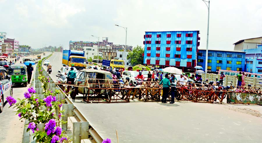 Barricades put in place on Buriganga Bridge (Bangladesh-China Friendship Bridge-1), popularly known as Postogola Bridge on Tuesday as the authorities suspend vehicular movement on the bridge for repairing work.