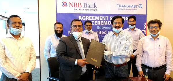 Md Mehmood Husain, Managing Director and CEO of NRB Bank Limited and Mohammad Khairuzzaman, Country Director-Bangladesh of Trans-Fast Remittance LLC (TRANSFAST), exchanging documents after signing an agreement at the Corporate Head Office of the bank in t