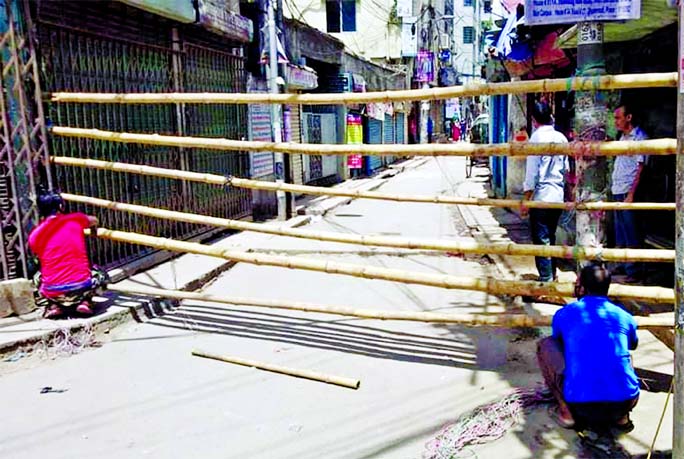 Bamboo poles set up to create roadblock on a neighbourhood of Dhaka South City's Ward No. 41 in Wari which goes into a three-week lockdown from today to contain the spread of coronavirus.