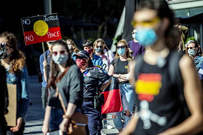 Protesters participate in a Black Lives Matter (BLM) rally, calling for an end to police brutality against Black people in the United States and First Nations people in Australia, in Brisbane on Saturday.