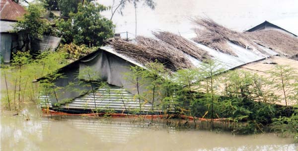 Many houses go under floodwater in Sholiabari and Kalishakura villages under Sirajganj Sadar upazila. The snap was taken on Saturday.