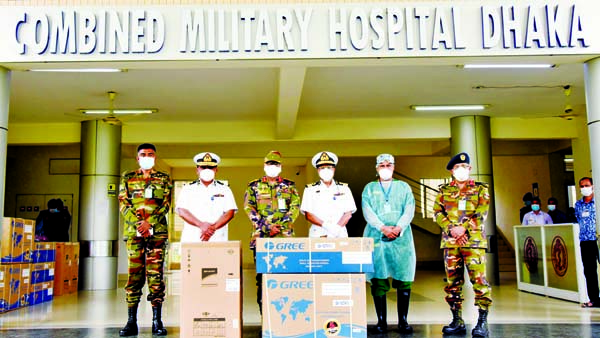 Officials of Combined Military Hospital Dhaka and Bangladesh Navy pose for a photograph as the latter gives away fridge and air-conditioner to the Corona Unit of the hospital at a simple ceremony on Sunday. ISPR photo