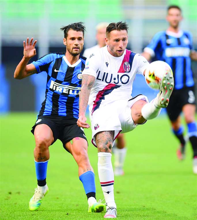 Bologna's Mitchell Dijks (front) vies with FC Inter's Antonio Candreva during a Serie A football match between FC Inter and Bologna in Milan, Italy on Sunday.