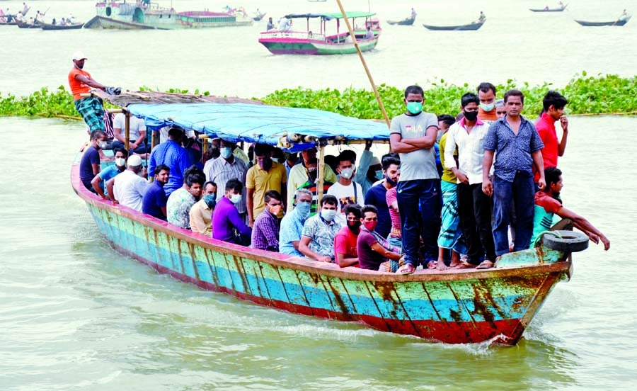 Commuters continue to cross the Buriganga River by wooden engine boat from Keraniganj to Dhaka everyday taking risk of lives even after seven days of the capsize 'Morning Bird' in the river that claimed 34 lives. This snap was taken on Monday.