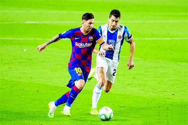 FC Barcelona's Lionel Messi (left) vies with RCD Espanyol's Marc Roca during a Spanish league football match between RCD Espanyol and Barcelona in Barcelona, Spain on Wednesday.