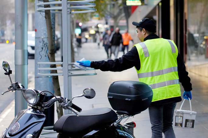 An essential worker sanitises surfaces after lockdown restrictions were implemented in response to an outbreak of the coronavirus in Melbourne on Friday.