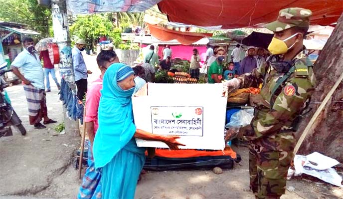 Bangladesh Army distributes relief materials among the distressed people in Barishal on Friday with a view to tackling coronavirus crisis.