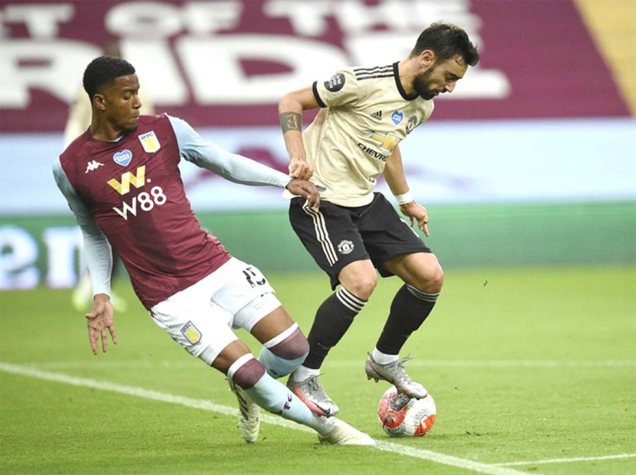 Manchester United's Bruno Fernandes (right) is tackled by Aston Villa's Ezri Konsa during the English Premier League soccer match between Aston Villa and Manchester United at Villa Park in Birmingham, England on Thursday.